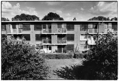 350986 Gezicht op de achterzijdes van enkele dichtgetimmerde en voor sloop bestemde flatgebouwen aan de Pionstraat ...